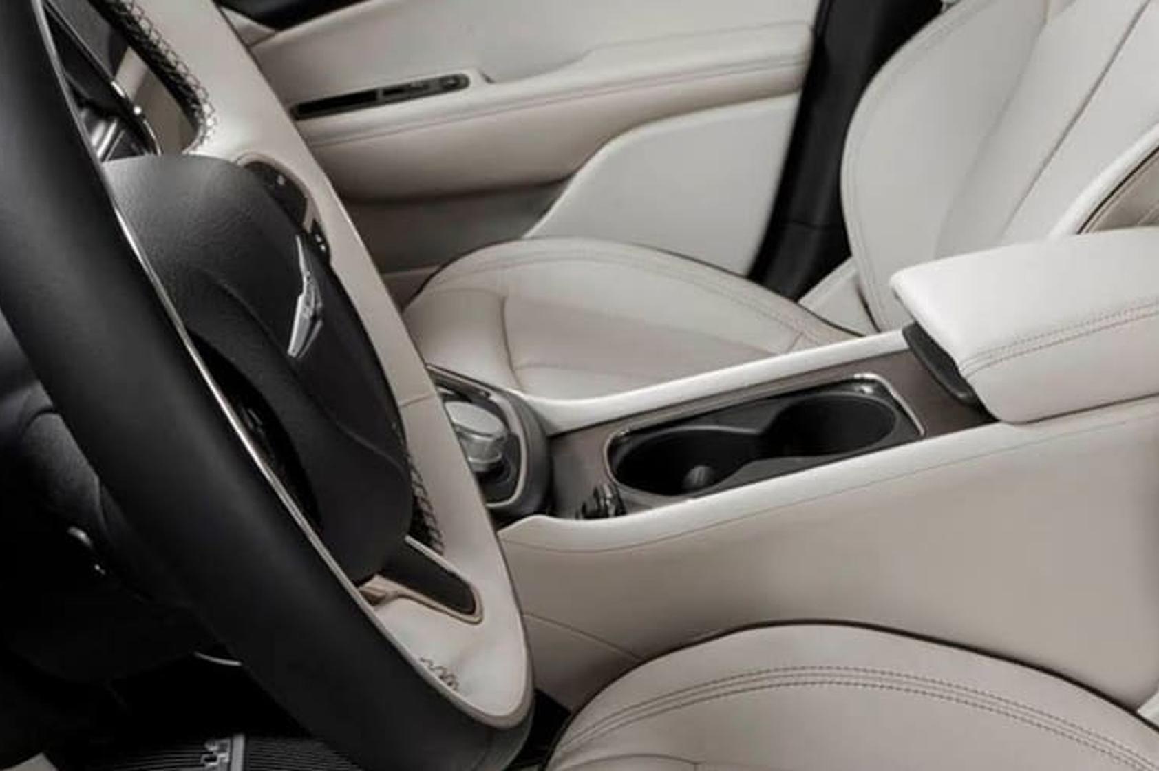 Automotive interior featuring Gslide system in armrest and center console drawer